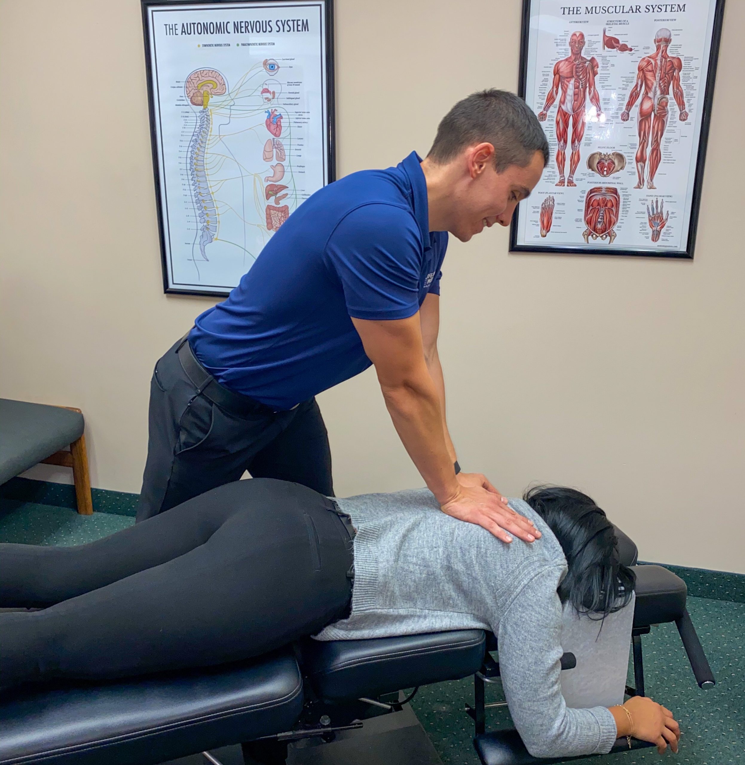 Dr. Dockery performing a chiropractic adjustment at Life in Motion Chiropractic Livonia MI