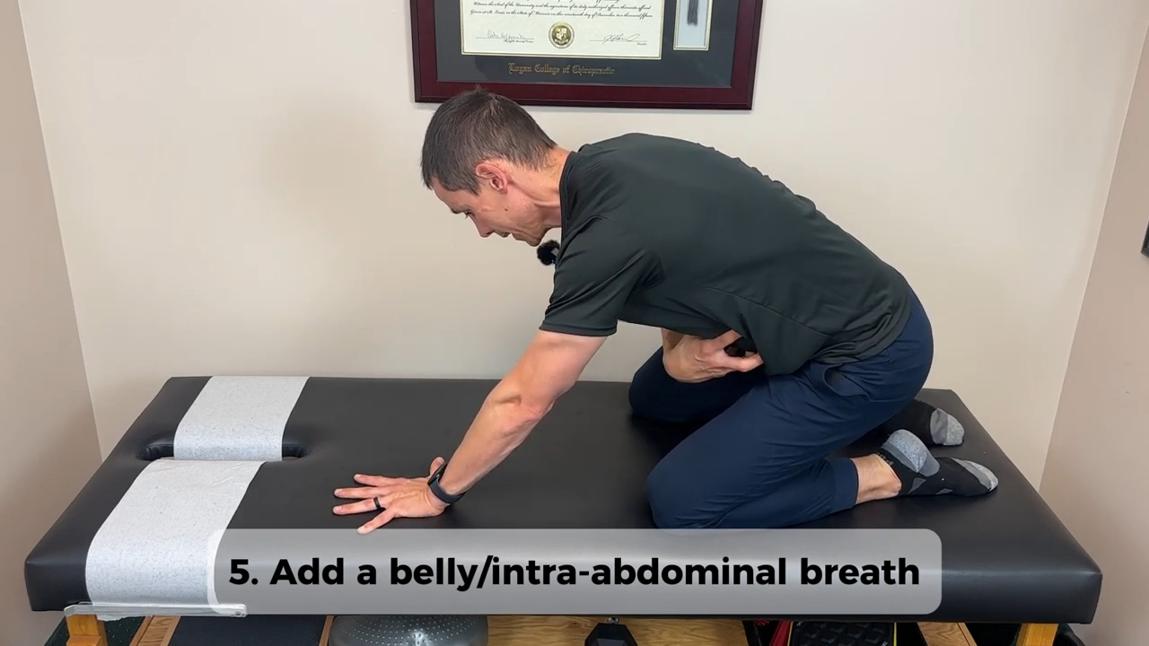Dr. Dockery demonstrating the Lumbar Cat Camel with Breath exercise — Life in Motion Chiropractic Livonia MI
